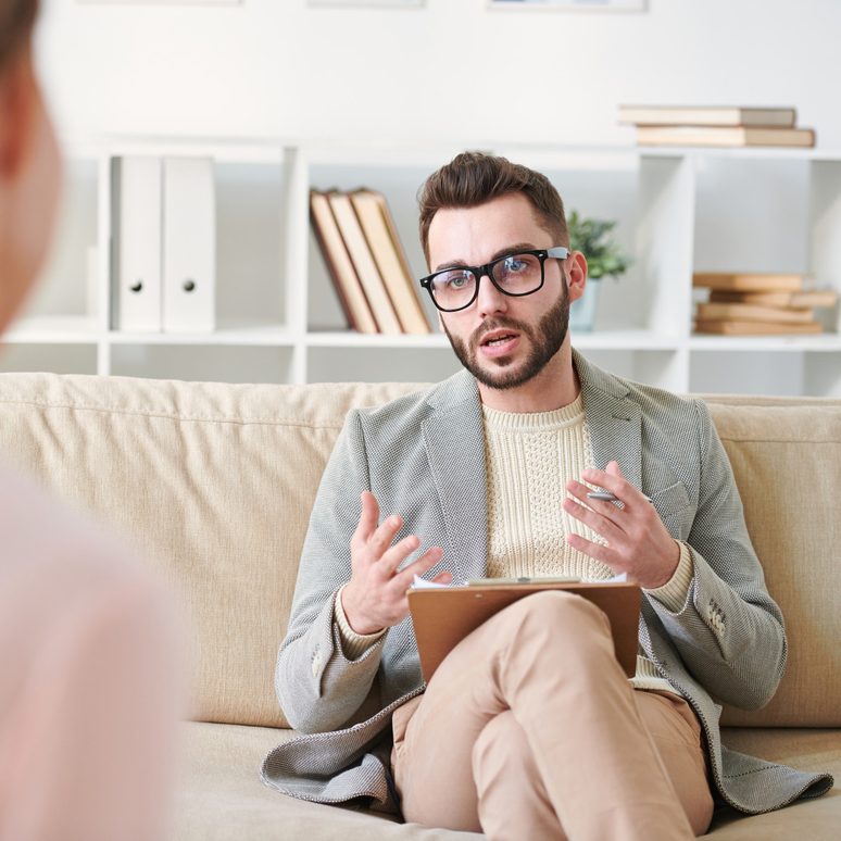 A consultant on a sofa working through a brand brief on a tablet